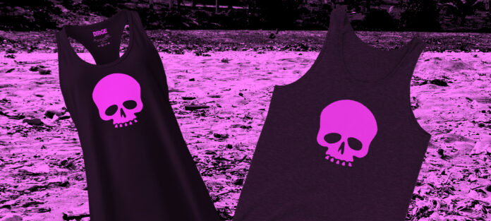 A Dirge Racerback and traditional Tank Top in front of a dirty beach.
